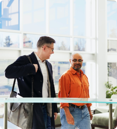 Two men walking while in conversation