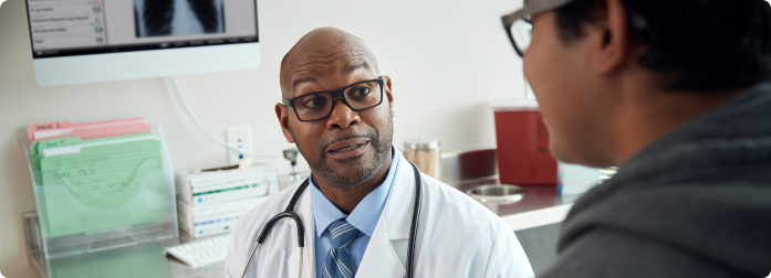 A doctor carefully listening to a patient