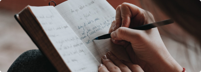 A woman wrting in a journal