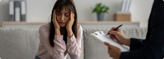 A medical professional is taking notes during a patient visit