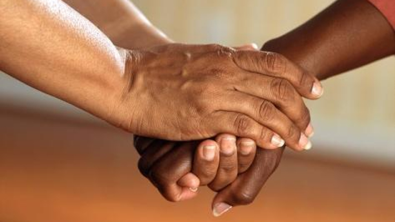 Two people holding hands